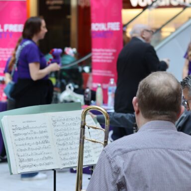 Man sat with his back to the camera looking at sheet music.