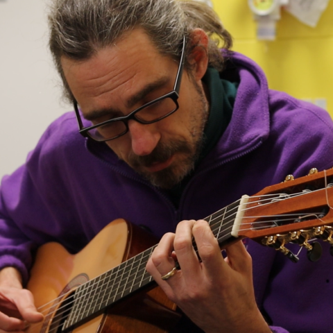 A man playing the guitar.