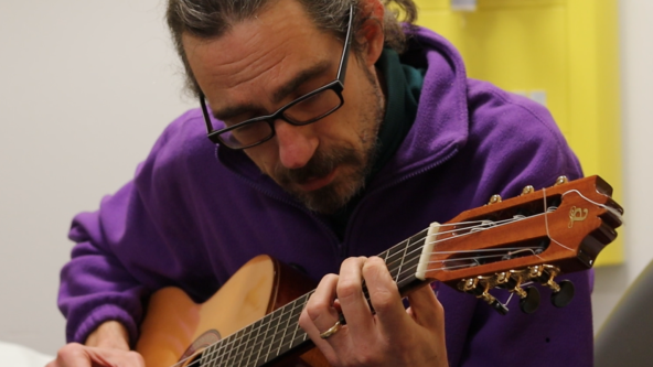 A man playing the guitar.