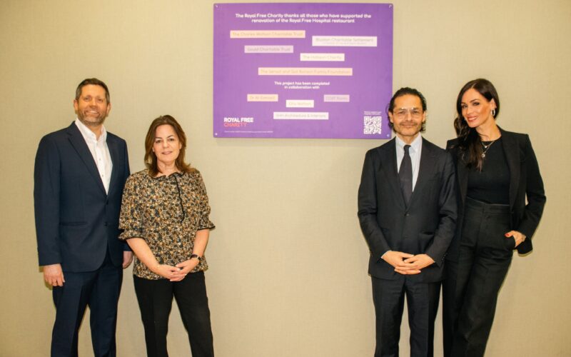 Jon Spiers, Judy Dewinter, Dr Ali Esmaeili and Orly Wolfson in front of a purple plaque.