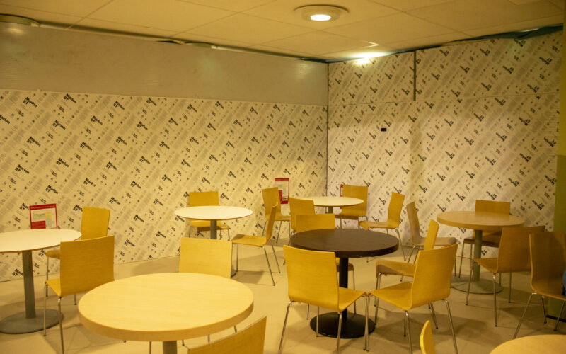 Tables and chairs in a hospital restaurant before refurbishment.