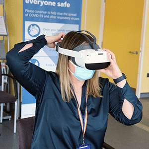 Laura using a VR headset at staff wellbeing VR workshop at Chase Farm