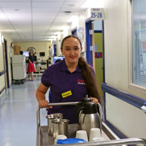 Danielle, our volunteer in the corridors of the hospital with a trolley 