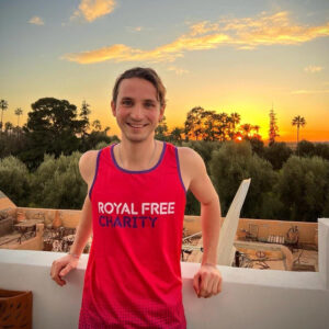 Billy wearing a Royal Free Charity running vest as the sun sets over Marrakech.