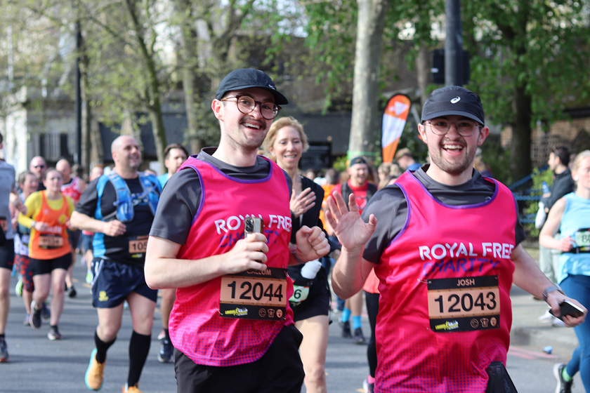 Two brothers in Royal Free Charity shirts, running with others during a race in London.